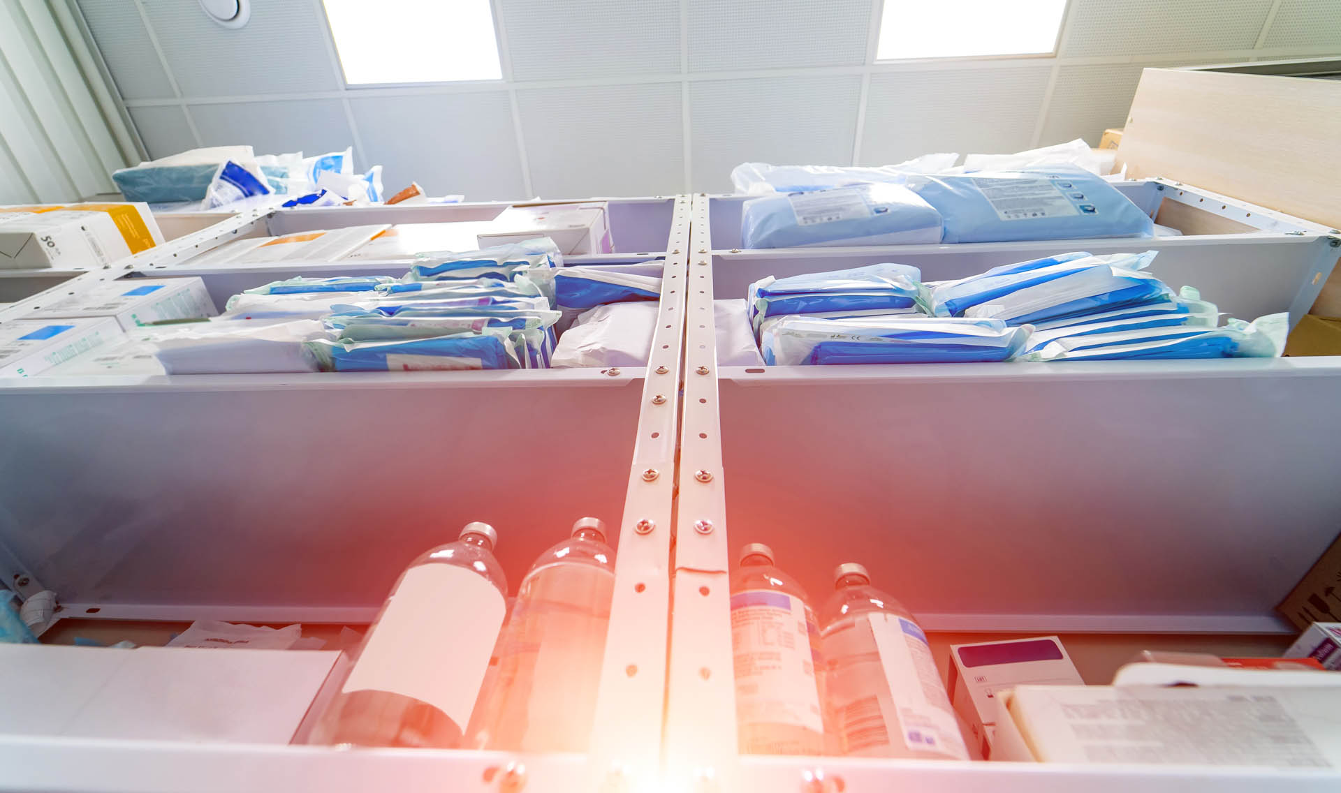 Stocked shelves of medical scrubs in storeroom.